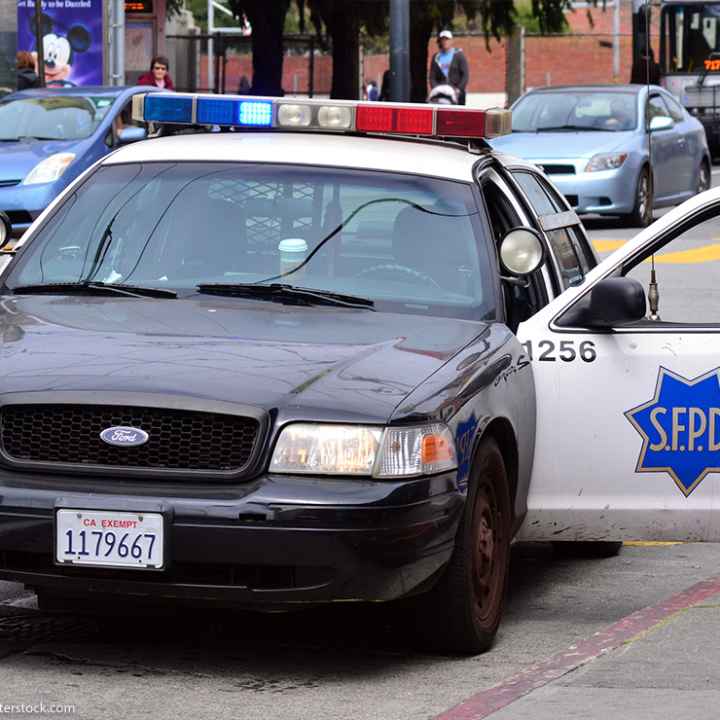 Modern SFPD police car cruiser with the door on the driver side open.