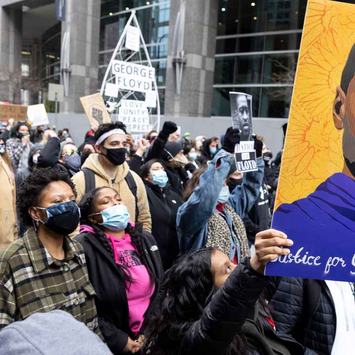 Protestors holding up a portrait of George Floyd